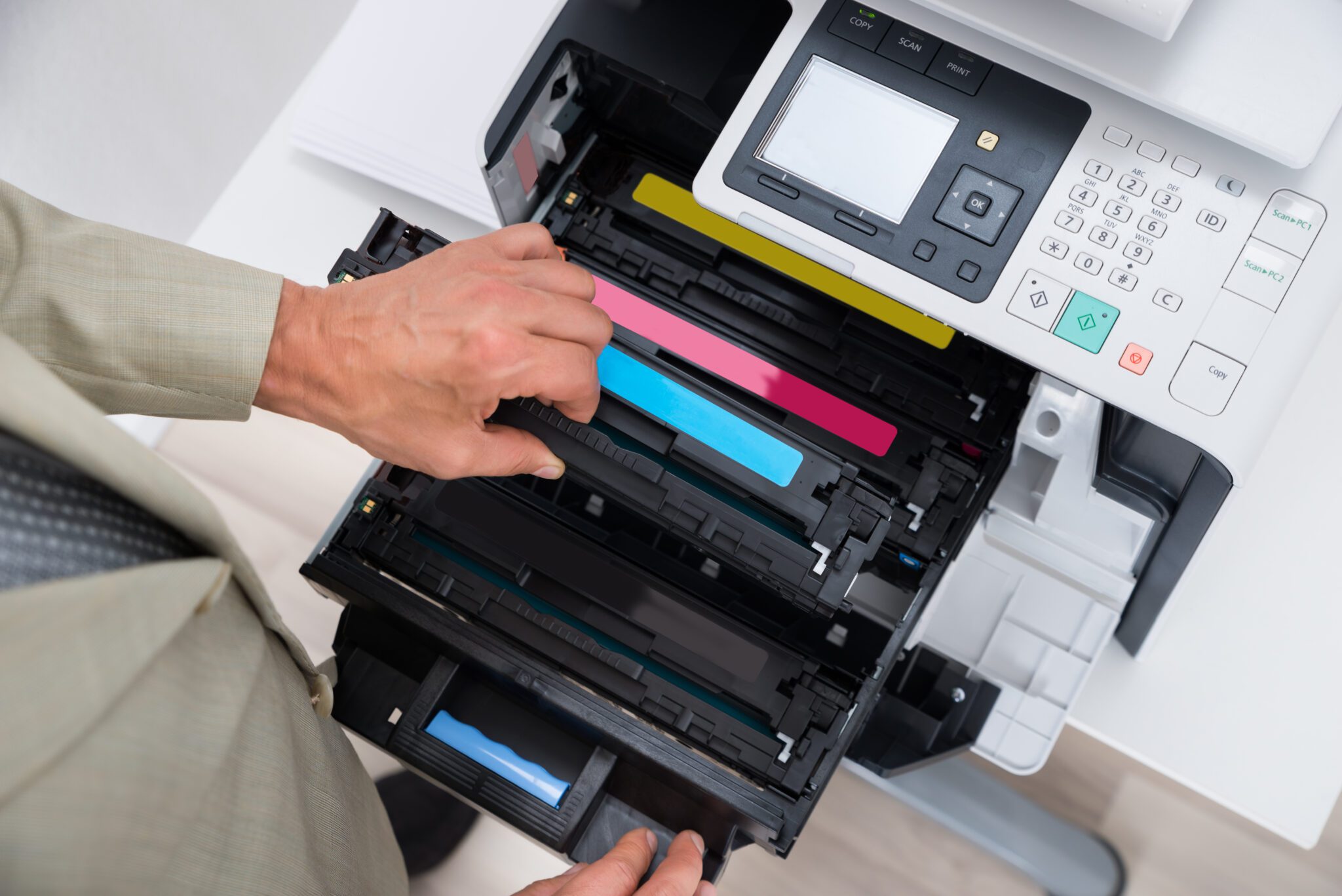 Businessman Fixing Cartridge In Photocopy Machine Cropped image of businessman fixing cartridge in photocopy machine at office